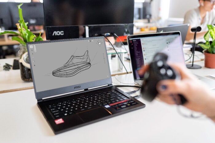 A design engineering working on a blueprint of a shoe