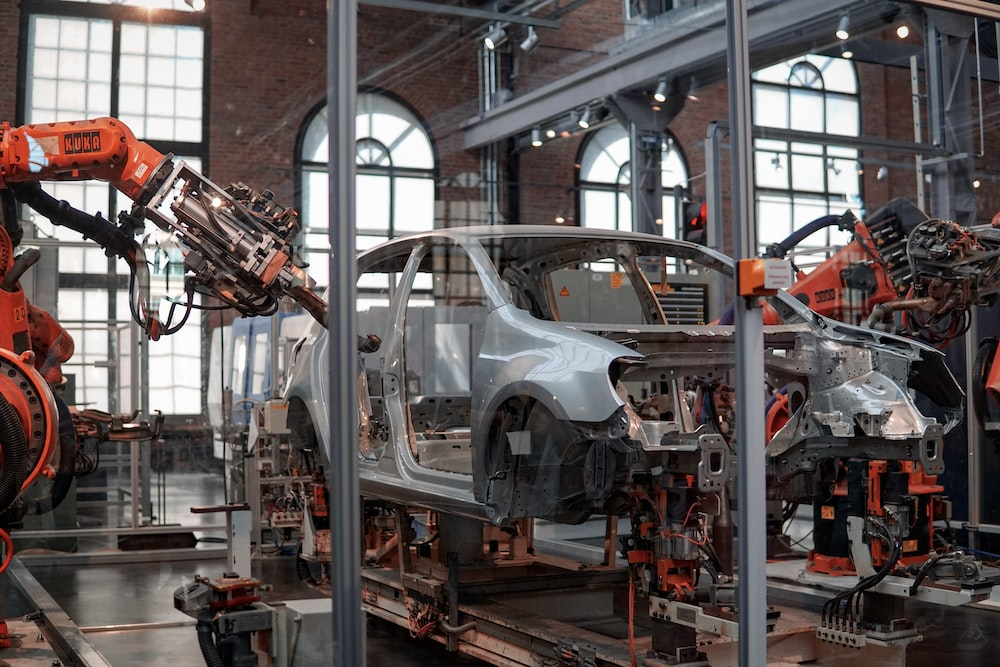 Machines are fixing a car in an automotive factory